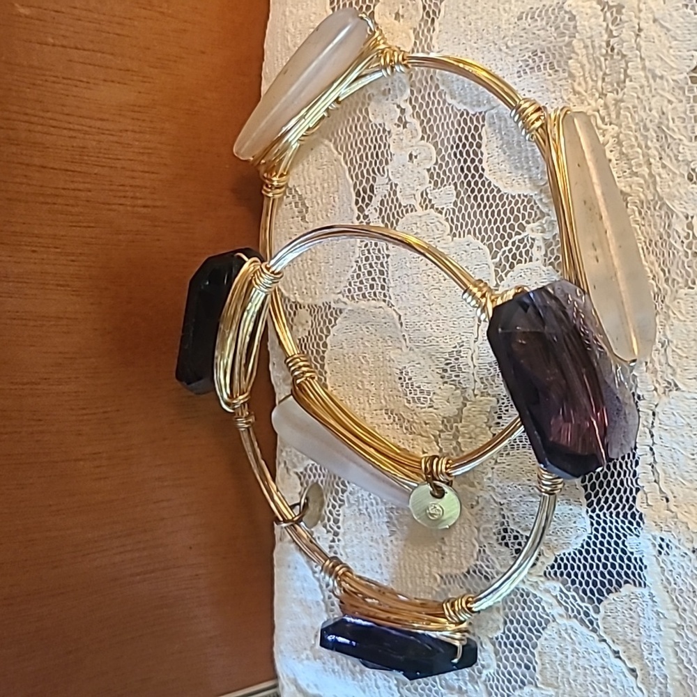 Two stackable wire bracelets gold color with purple and white beads